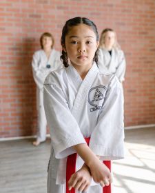 Girl with red belt performing a pattern